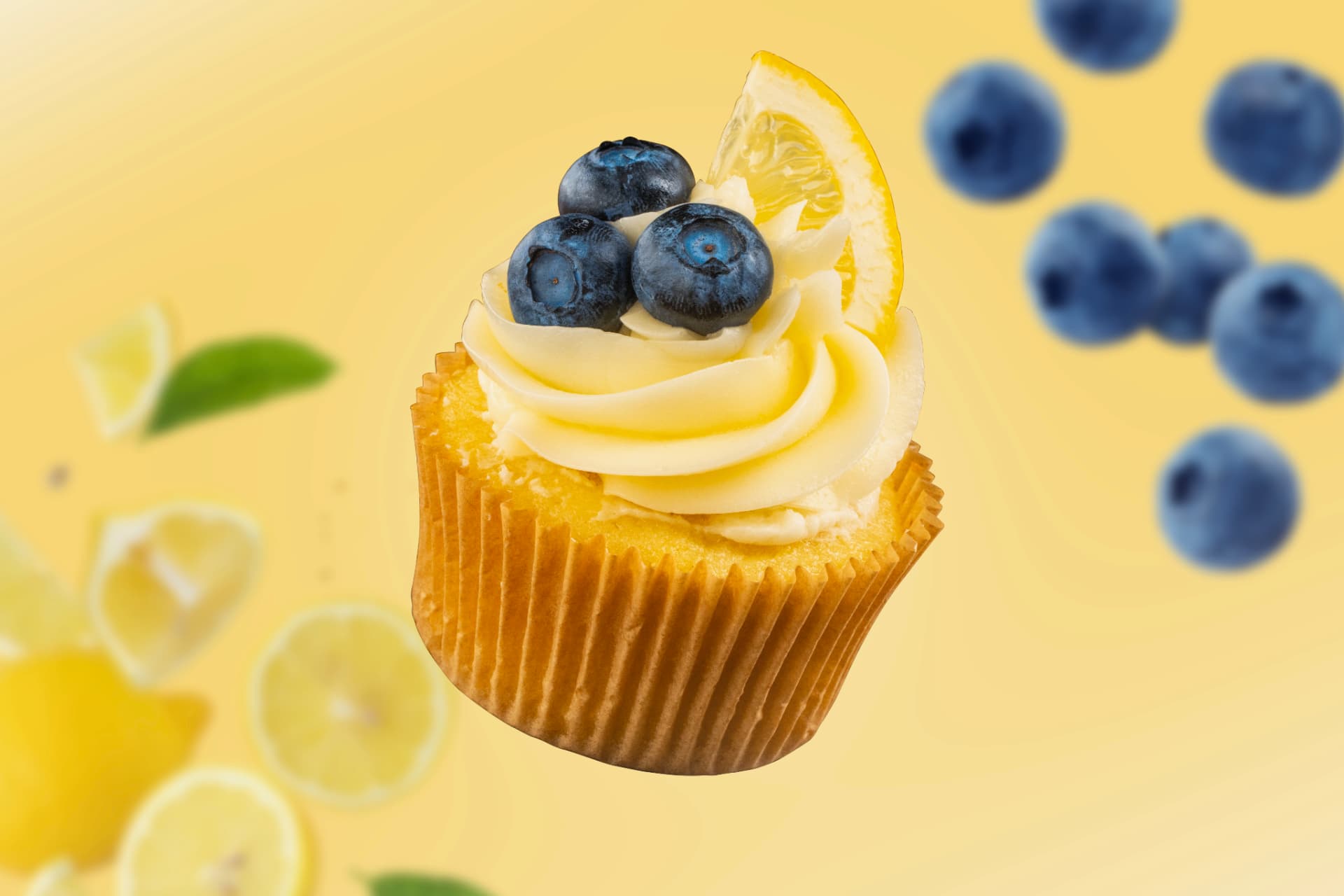 A lemon blueberry cupcake with swiss meringue buttercream, fresh blueberries, and a lemon wedge floating against a sunny yellow backdrop