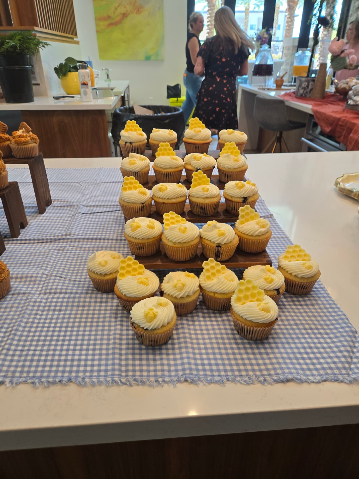 Cupcakes with white honey buttercream topped with yellow honeycomb and bee decorations