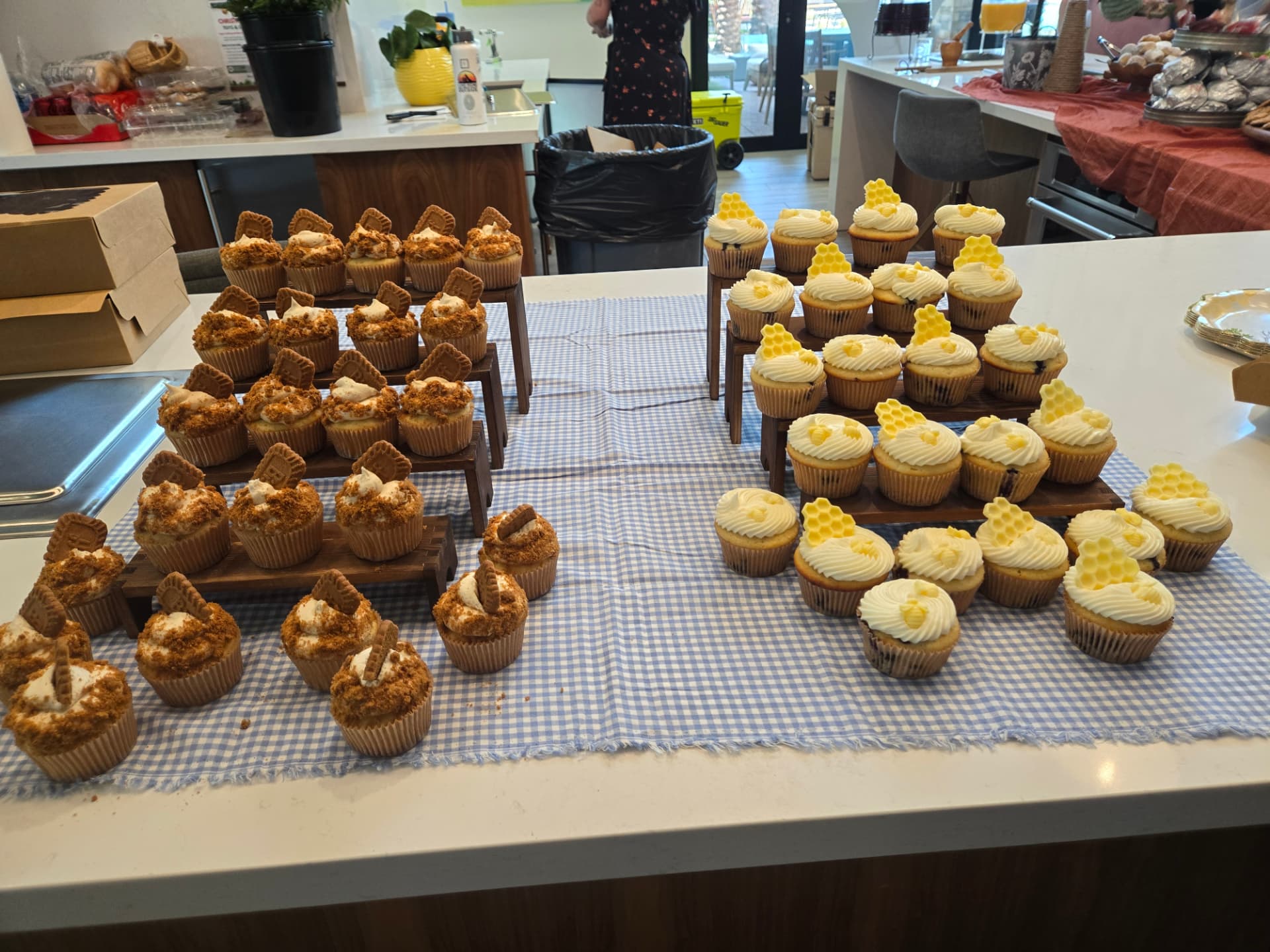 A dessert table with Biscoff cupcakes on one side and honeycomb cupcakes on the other